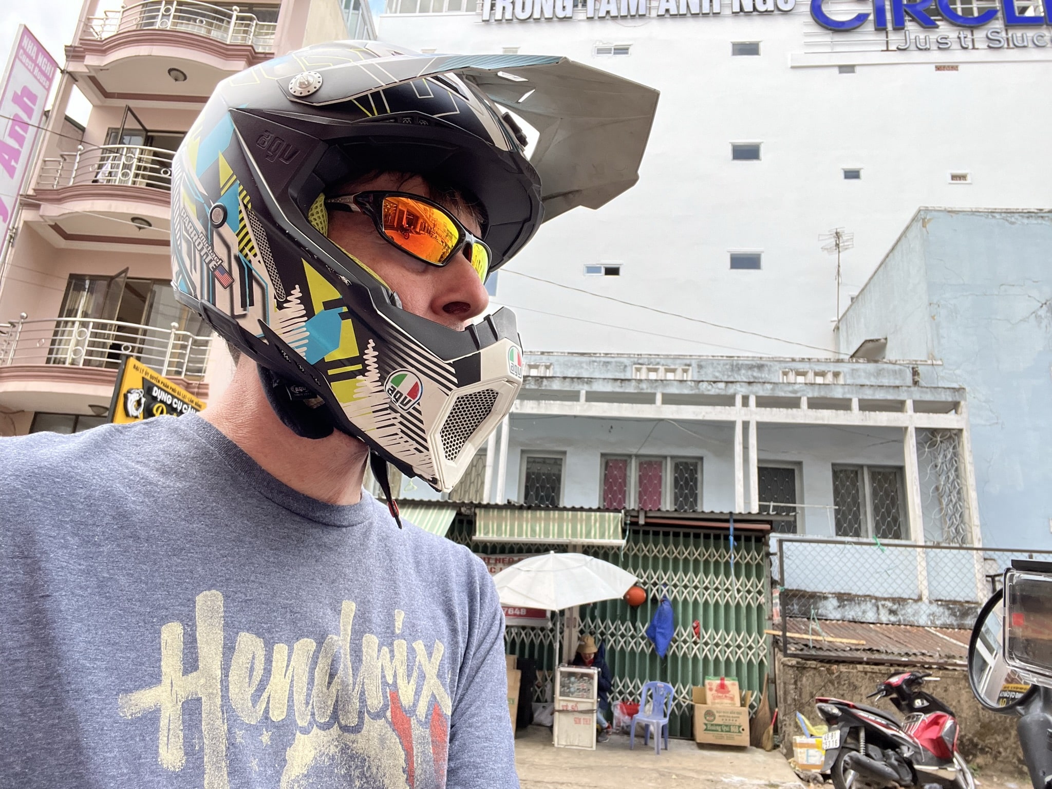 Donning my AGV AX-8 EVO helmet on the bustling streets of Thailand last year. The AX-8 has now been replaced with the AX-9, which is one of the most comfortable adventure touring helmets I have ever worn. Photo by Michael Parrotte.