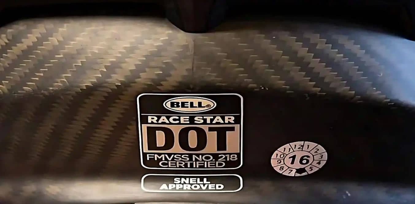 The BELL Race Star helmet showcasing the DOT FMVSS No. 218 and SNELL-approved stickers. The SNELL Memorial Foundation tests are stricter than the FMVSS No. 218 tests. While the SNELL tests do not affect what is legal to sell anywhere in the United States, they prove that a helmet goes beyond the usual standard and offers excellent protection.